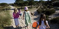 Children walking through the nature reserve to the dunes and beach at Studland, Dorset